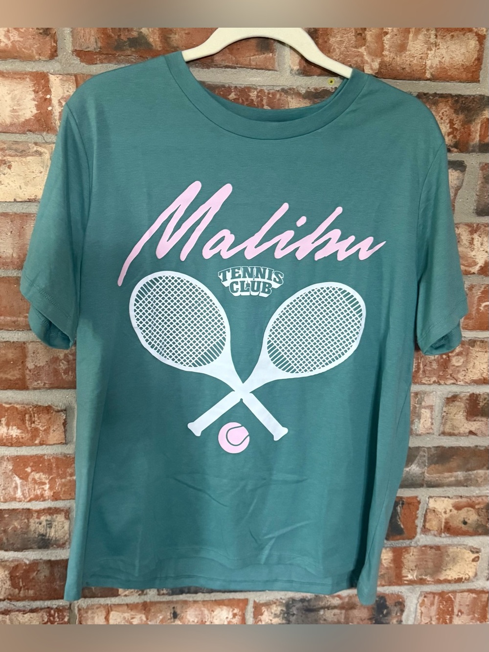 Grayson Threads Teal Malibu Tennis Club Short Sleeve Tee with Pink Graphics